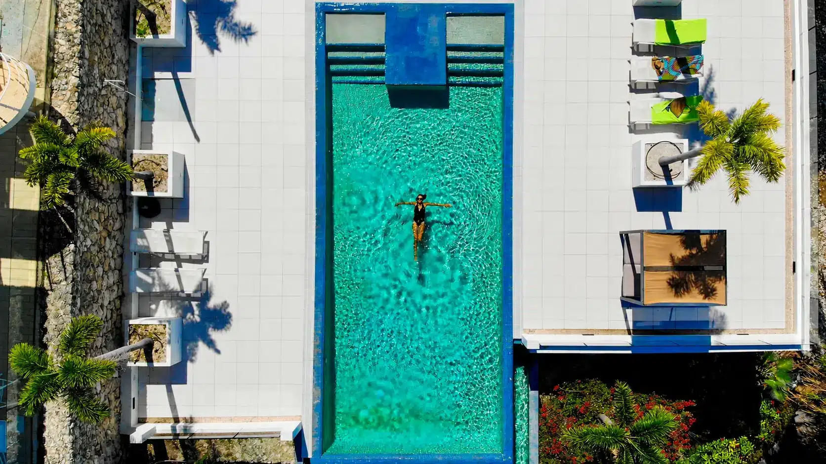 Aerial view of the pool, palms and sun deck at Piscadera Harbour Village in Curaçao